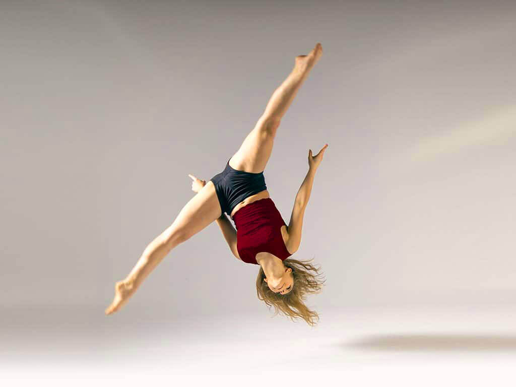 professional aerial dancer performing silk and hoop on stage